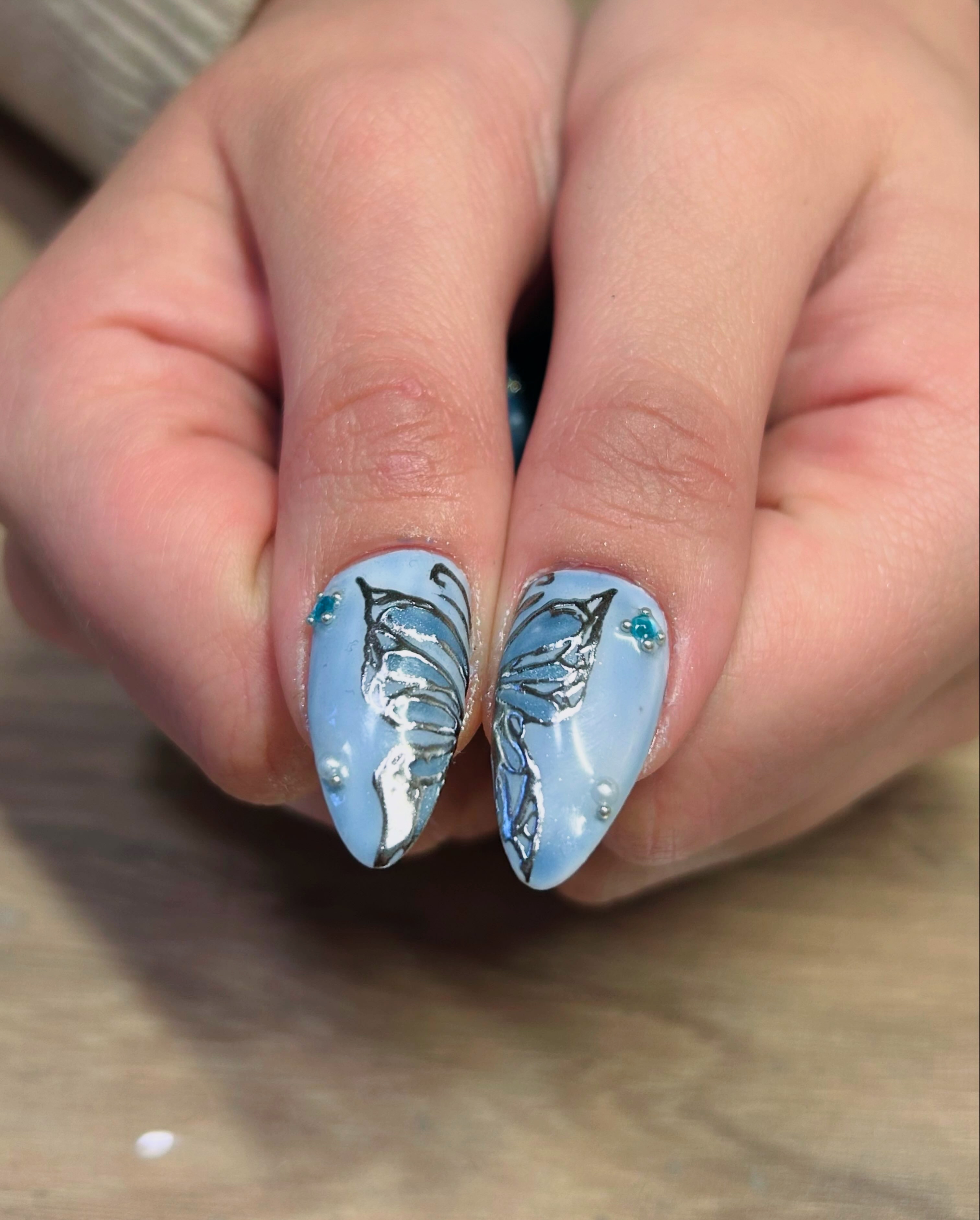 Blue nails with silver butterfly design