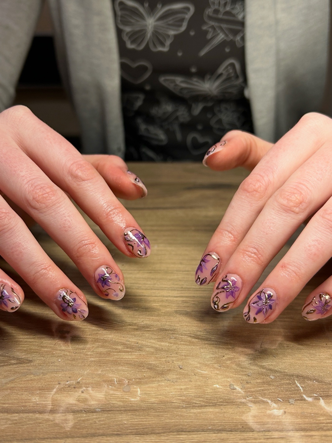 Purple floral nail art with gold accents